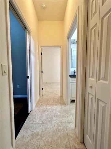 hallway exiting front guest bedroom toward guest bath and 3rd bedroom