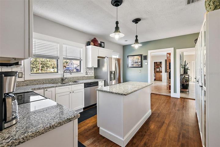 What a kitchen! Original hardwood floors, Granite countertops, stunning stainless appliances
