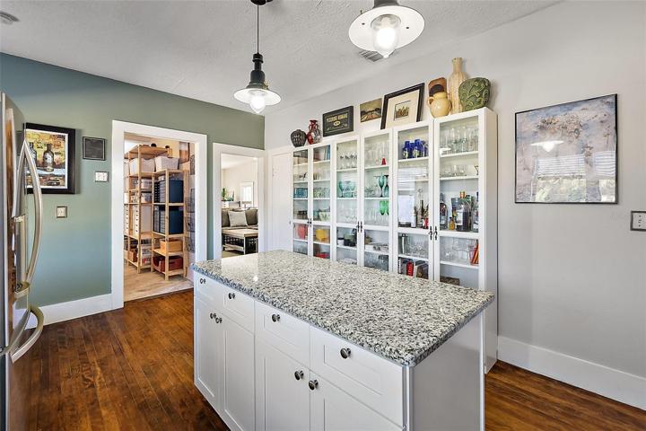 Beautiful glass front shelving in the kitchen will convey!