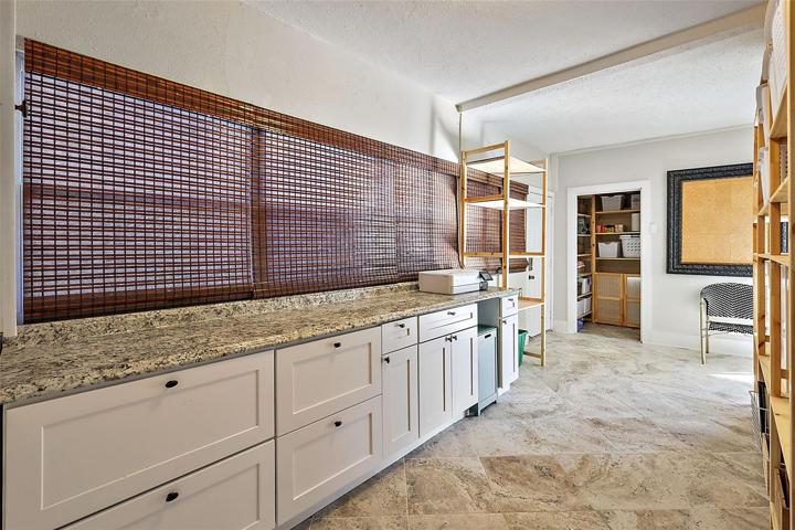 Utility room with ceramic tile and built in cabinetry