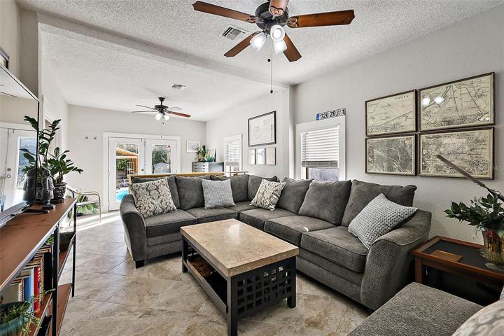 Family room with ceramic tile and French doors that lead to the backyard/pool