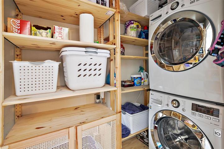 Laundry room just off the utility room with more storage!