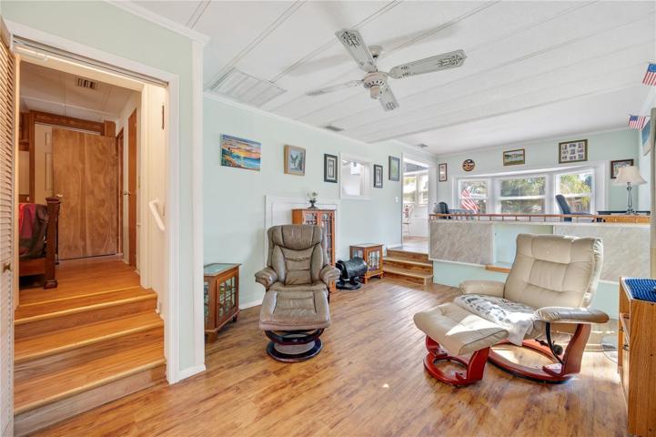 Living room with stairs to primary bedroom