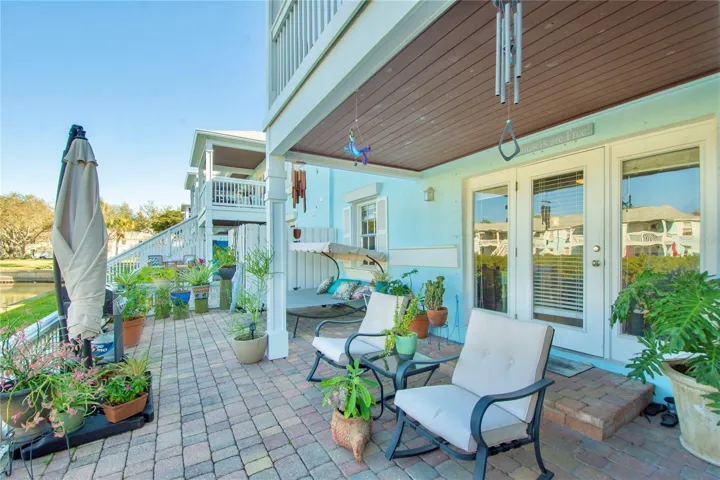 Private waterfront patio with French Doors to condo interior living area.
