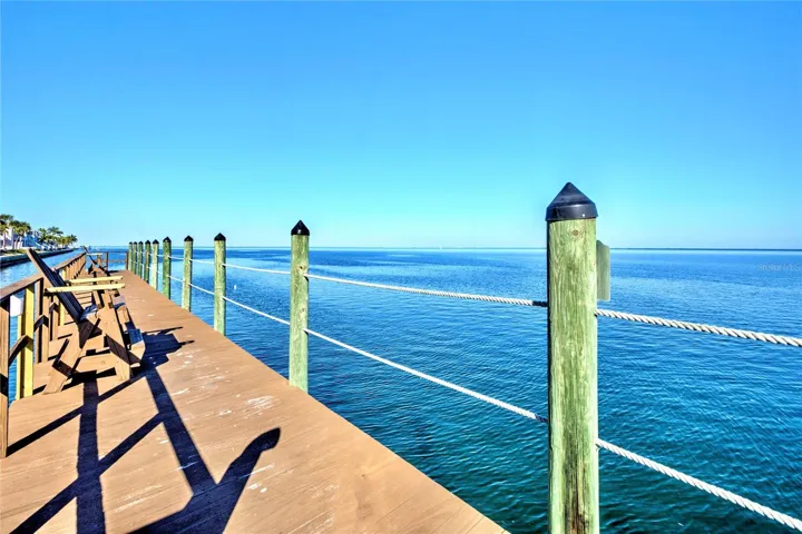 Private fishing pier at Yacht Club / Clubhouse / Pool with adirondack chairs for relaxing.