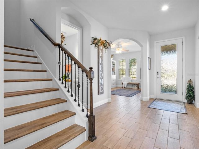 Upgraded Staircase with Wrought Iron Spindles, Luxury Plank Vinyl and White Risers!