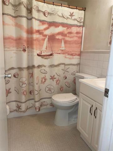 The hall bath has vanity and a tub with shower.