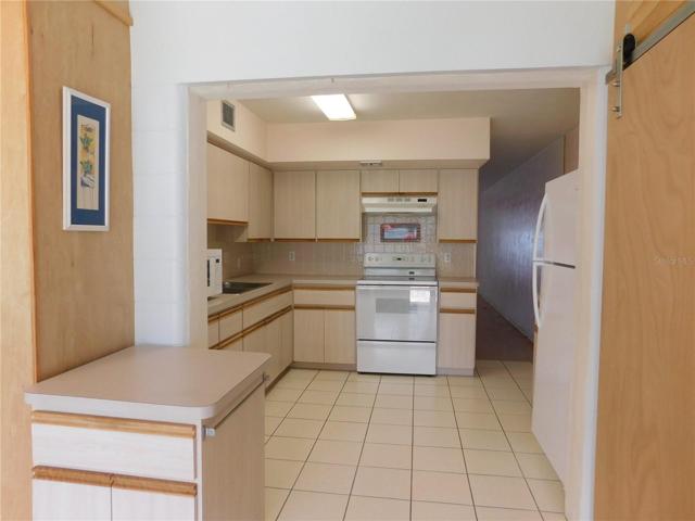 Kitchen from Florida Room showing rolling kitchen island.