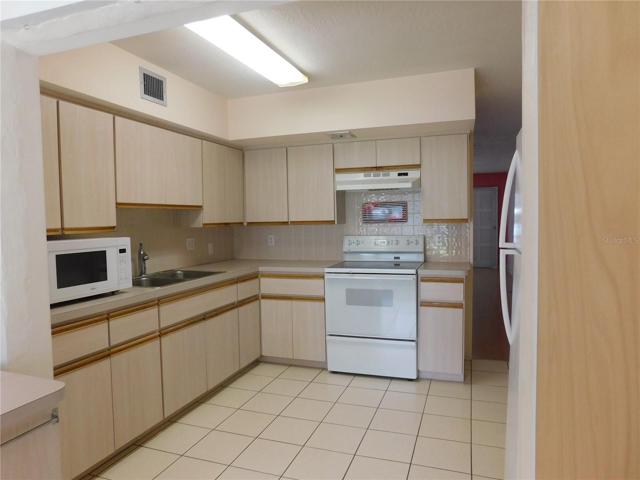 The Kitchen has a microwave, oven, refrigerator, and disposal.