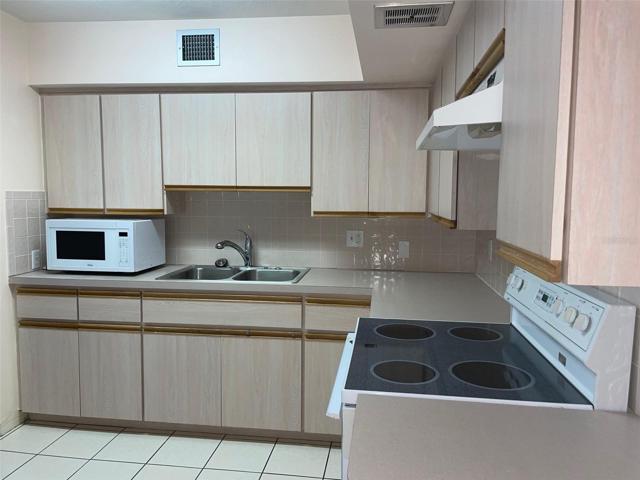 The kitchen boasts plenty of cabinets.