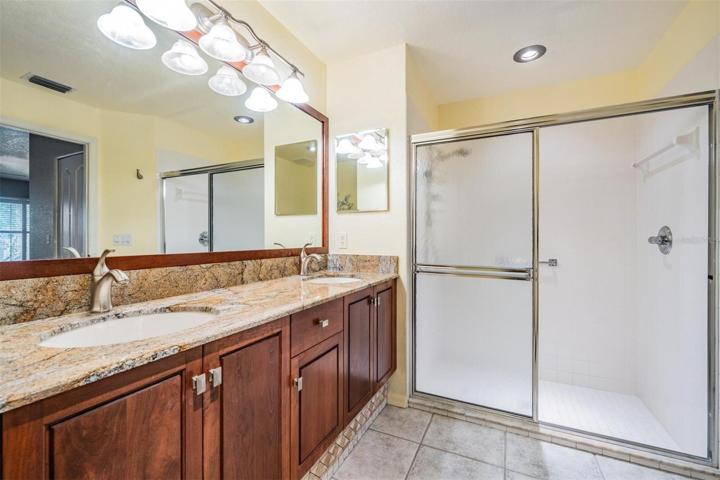 Master bathroom with large, step in shower and double vanity providing extra storage