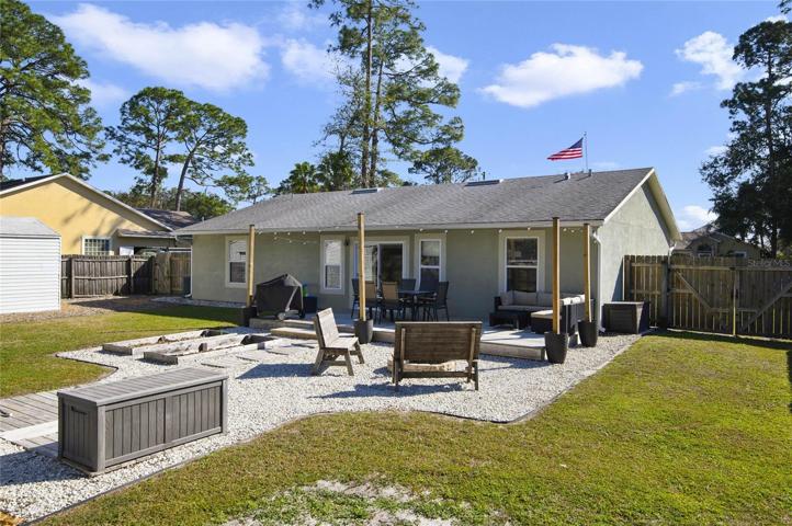 Fenced-in backyard with above ground pool and deck