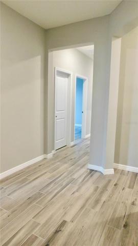 Large foyer is welcoming with designer gray tones - plank style ceramic floors throughout home! NO CARPET!