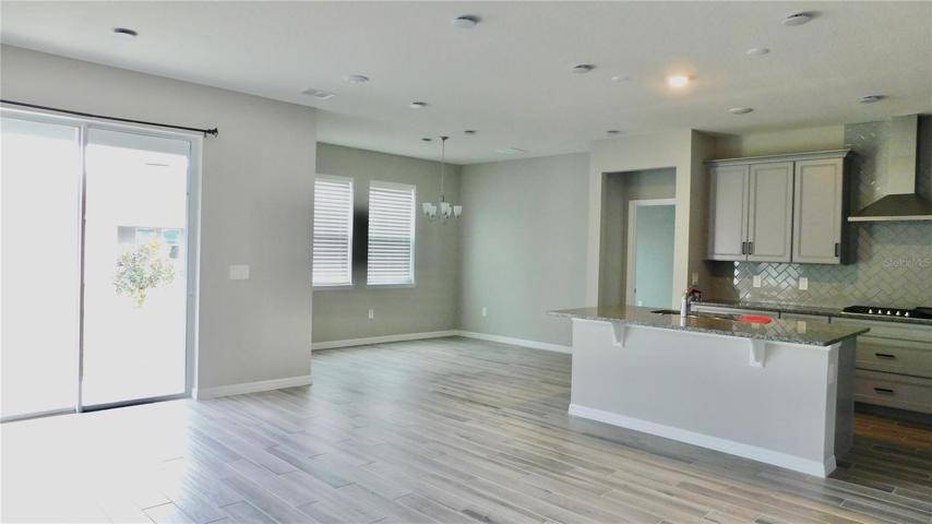Sliding doors expand your family room living outdoors. Designer colors and upgraded appliances and granite