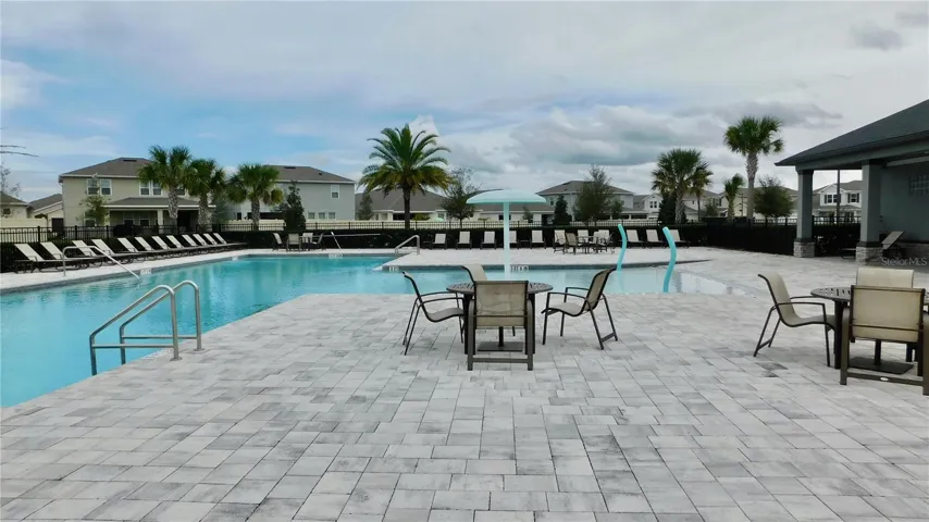 Resort style community  pool features clubhouse, chairs, splashpad and tons of space - Live like you are on vacation!