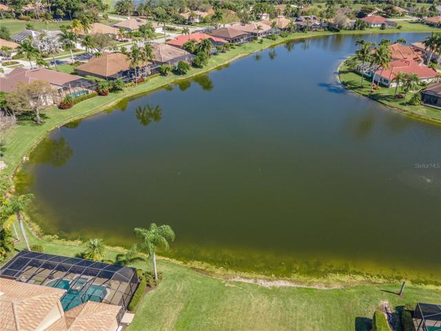 Aerial close up of vacant land and water across street