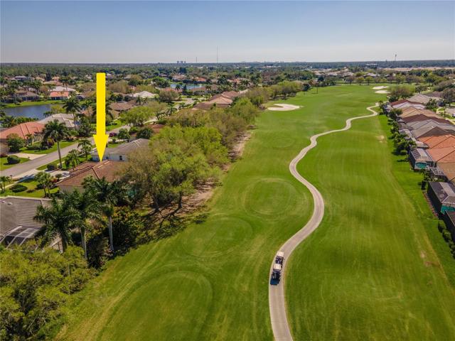 Aerial view of golf cart path and home marked with arrow