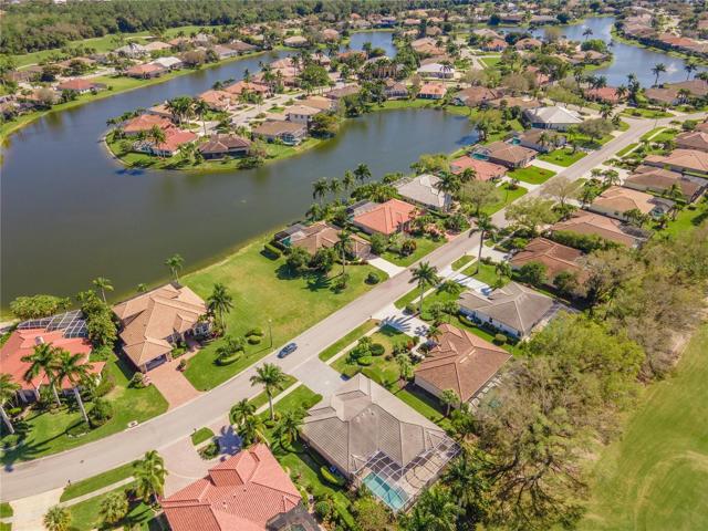 Aerial view of home, vacant land and water across street