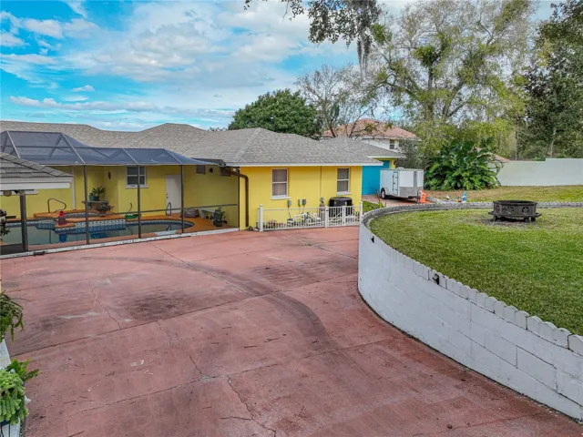 Another rear exterior view of house and part of the driveway.