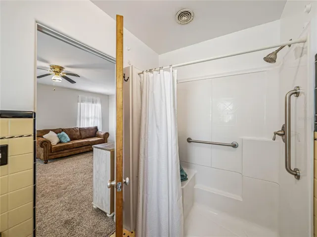 Walk-in shower with bench.