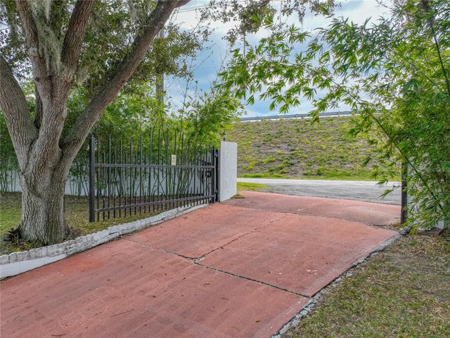 Other end of the driveway that exits to the road.  Gates are electronic.