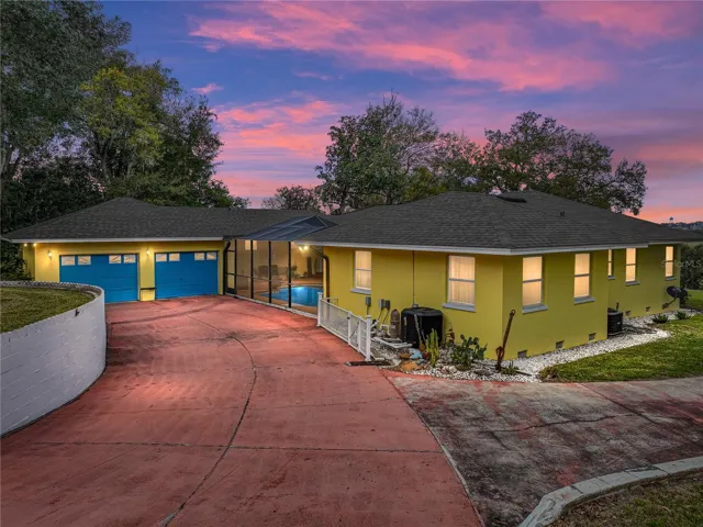 Oversized double garage has a side entrance into pool area and another entrance inside leading directly into the house.