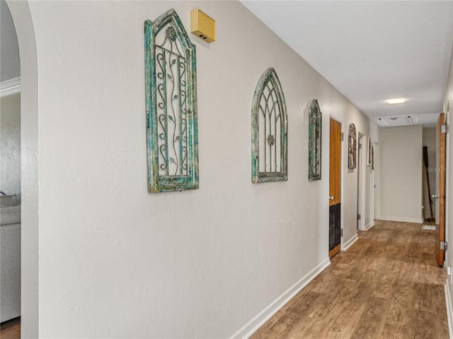 Hallway to the bedrooms and other 3 bathrooms.