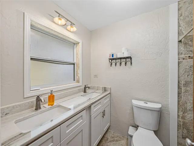 Renovated master bath with double sinks.