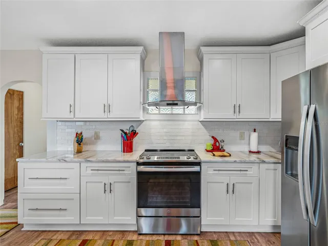 Beautiful stone countertops, wood cabinets and subway tile backsplash--simple elegance.
