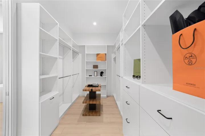 Custom closet system in oversized primary walk-in closet