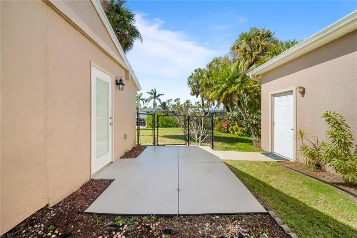 Patio connecting detached garage to side entrance of suite.