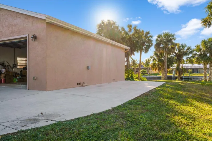 Parking pad next to detached garage.
