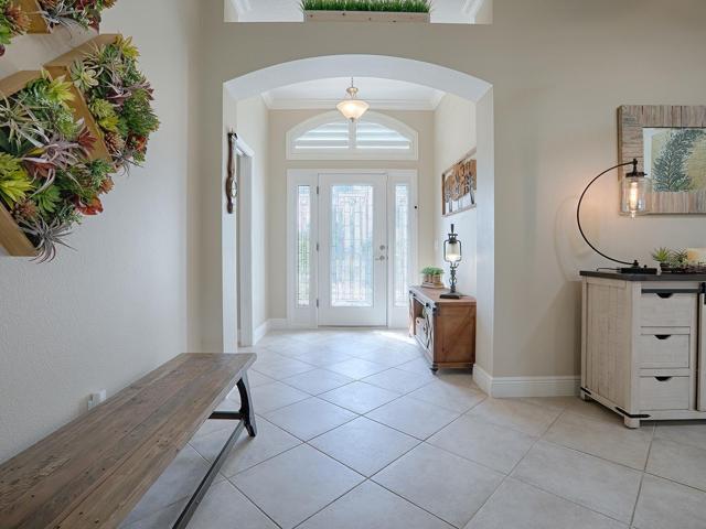 PLANTATION SHUTTERS ON THE TRANSOM OFFERS AN EVEN MORE ATTRACTIVE FOYER.