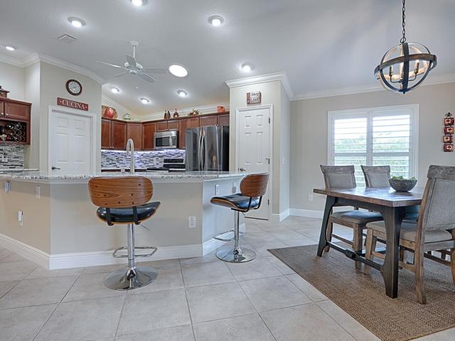 CASUAL DINING AREA - CUSTOM LIGHT FIXTURES AND PLANTATION SHUTTERS THROUGHOUT THE HOME.