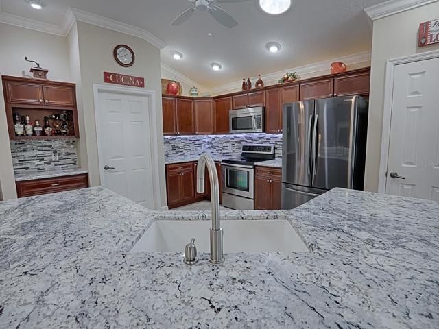 BEAUTIFUL GRANITE COUNTER TOPS AND GLASS TILE BACKSPLASH.