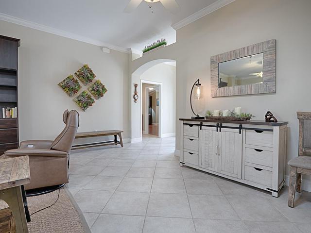 LOVELY DIAGONAL TILE THROUGHOUT THE LIVING AREA, HALLWAY, KITCHEN, LAUNDRY, AND BATHS.  THIS IS THE FORMAL DINING ROOM AREA SHOULD YOU NEED ONE.