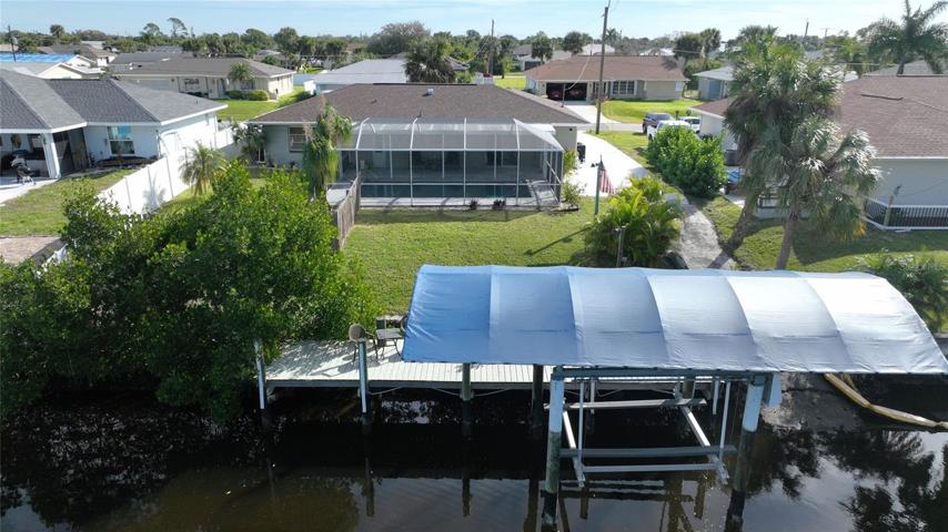 Rear view of the pool home on the waterfront.