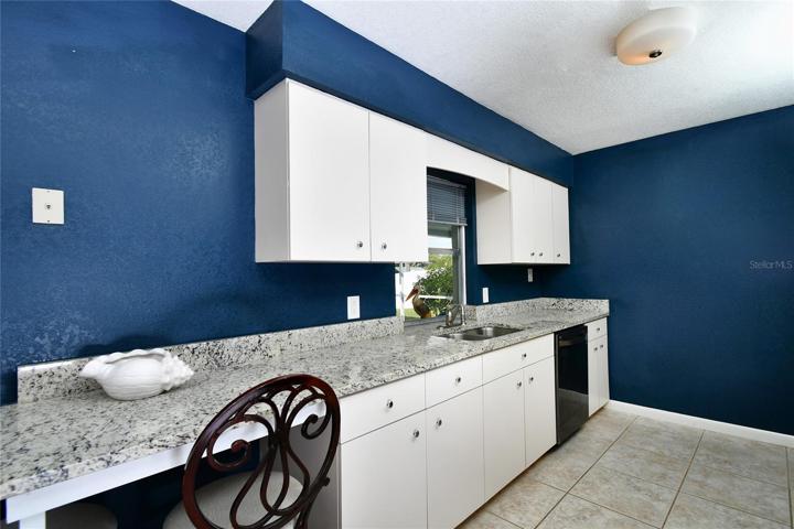 Nicely equipped kitchen with small office sitting area.
