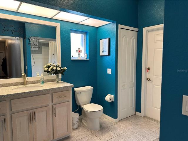 Bathroom 2 with pool access & linen closet