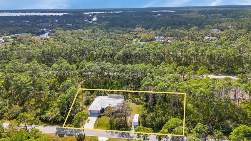 Sits on two lots & has one extra wooded lot