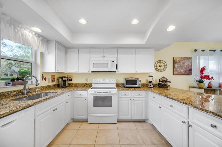 LARGE OPEN KITCHEN WITH WINDOW AND LOVELY GRANITE COUNTERTOPS