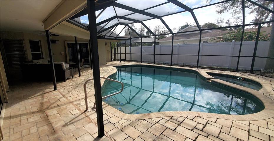 Large pool with Spa, paver deck, newer screen enclosure.
