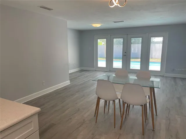 View from kitchen to pool through dining living area