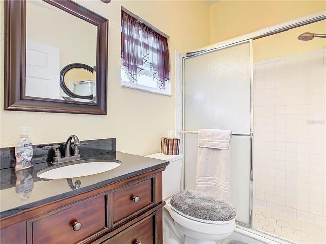 Master bathroom has a walk-in shower and granite counter top.
