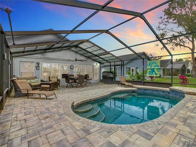 Pool includes spa jets and waterfall along with seating areas in the pool