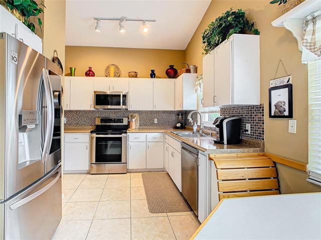 The kitchen has plenty of cabinets and counter top work space.