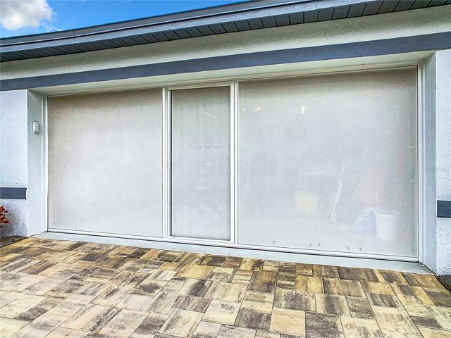2 car garage has skeeter-beater screen added to it with a walk-door.