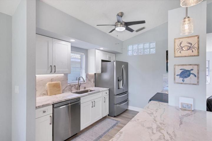 Recently updated kitchen with quality wood cabinets with soft close doors and under counter lighting, granite counters and LG stainless appliances.