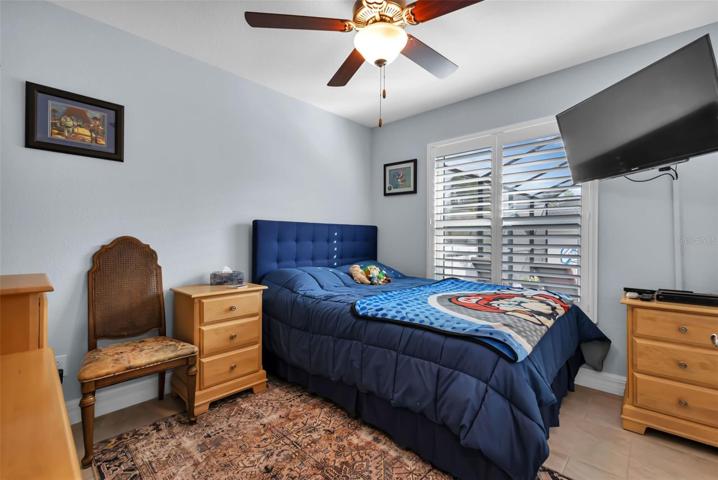 3rd Guest bedroom with closet, fan and plantation shutter.