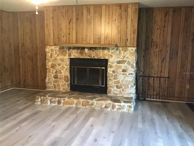 Rock faced fireplace with hearth and mantle